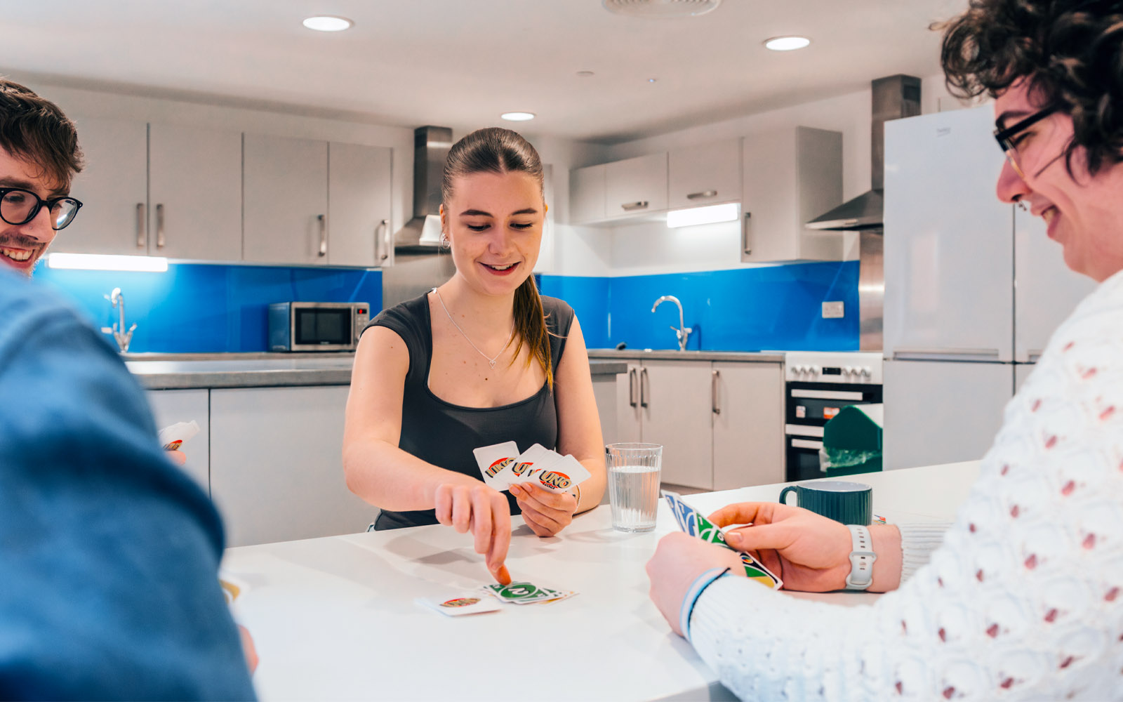 A group of students playing a game of cards