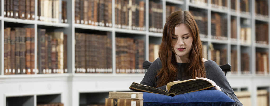 A student reading a manuscript in the archives