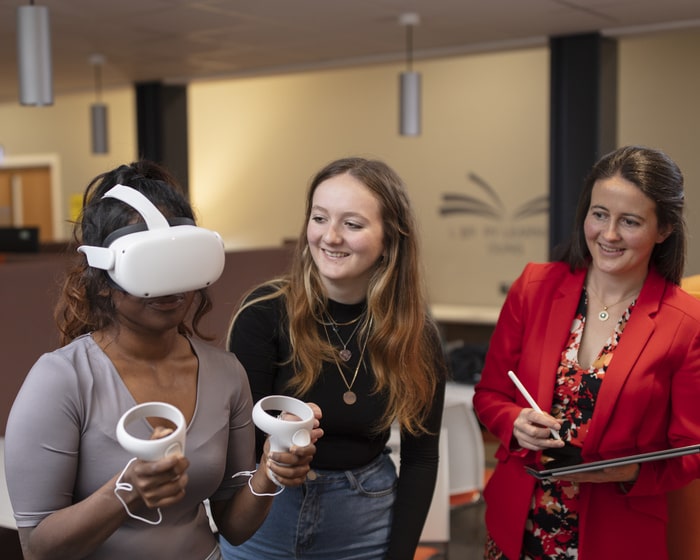 Students using VR equipment in a classroom