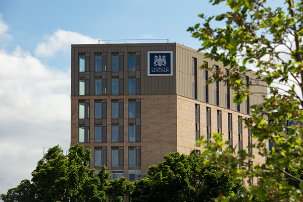 A building in the distance with the University of Lincoln crest on the side